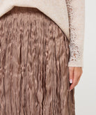 Close-up of the taupe Elara Crinkle Midi Skirt showing its softly crinkled, vertically textured fabric and fluid drape.