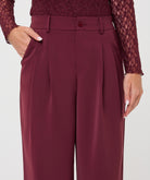 Model wearing merlot wide-leg trousers