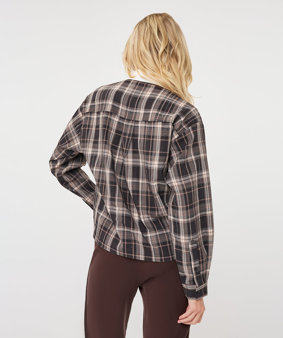 Model wearing a brown and taupe plaid short blouse with a white pointed collar and long sleeves
