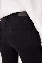 Black jeans with a visible brand label on a white background