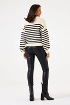 Model wearing high-waist City Edge vegan leather legging with a striped oversized sweater.