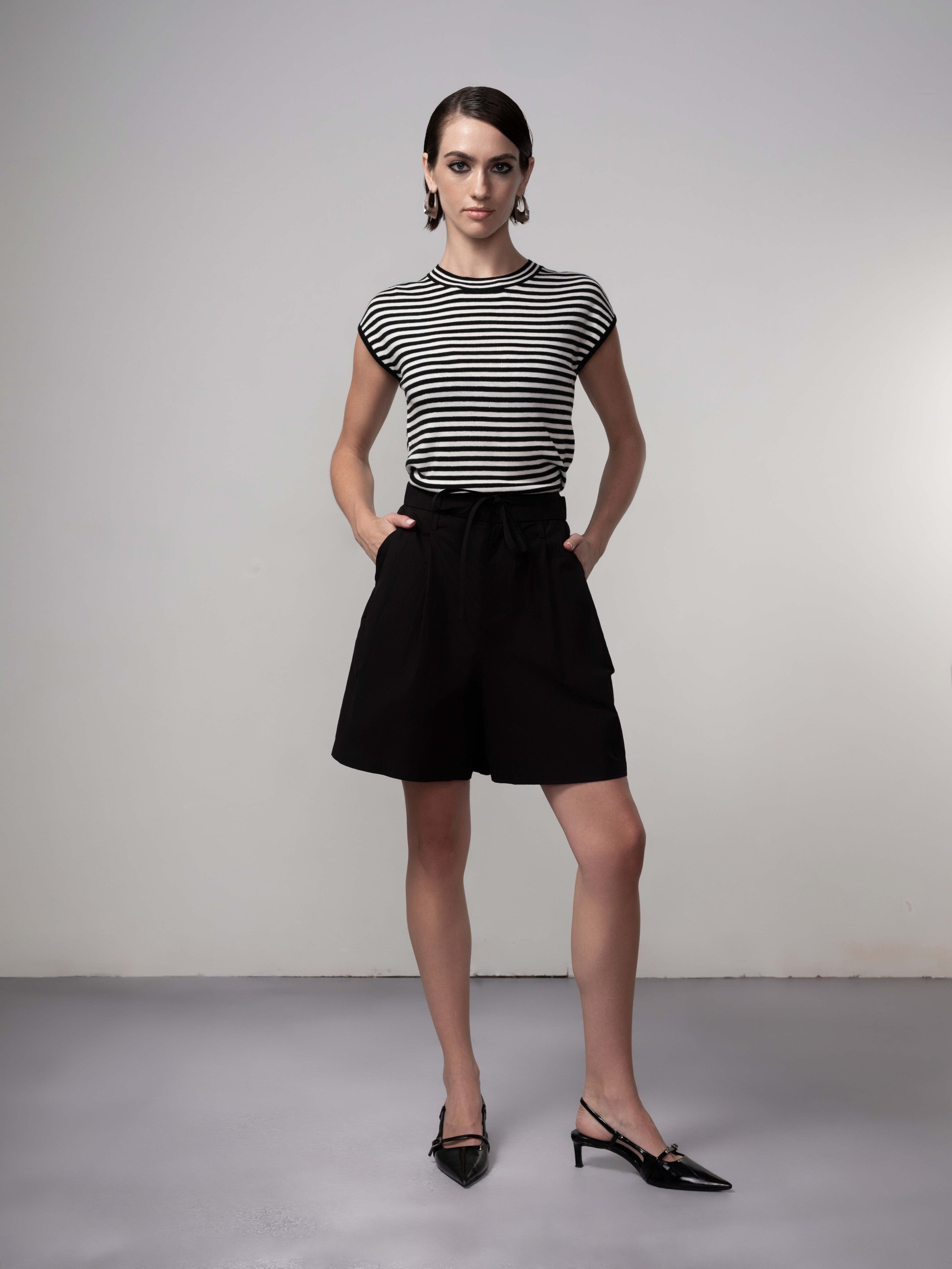 Woman wearing Brinley Easy Stripe Knit styled with high-waisted shorts, shown full length to highlight the relaxed silhouette and versatile everyday fit