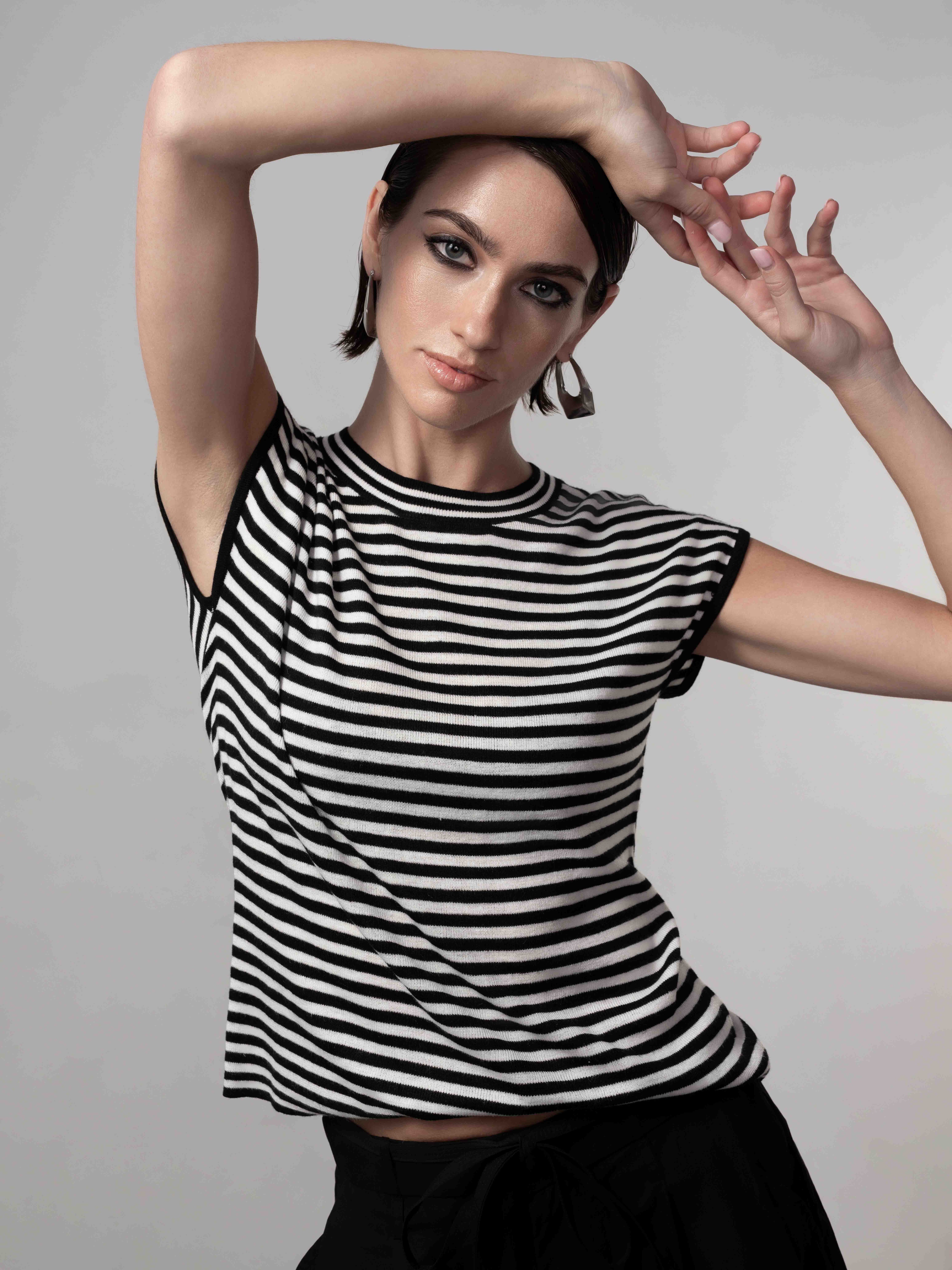 Woman wearing Brinley Easy Stripe Knit with relaxed fit, short sleeves, and crew neckline, shown in a styled close-up pose highlighting the soft knit texture and stripe pattern