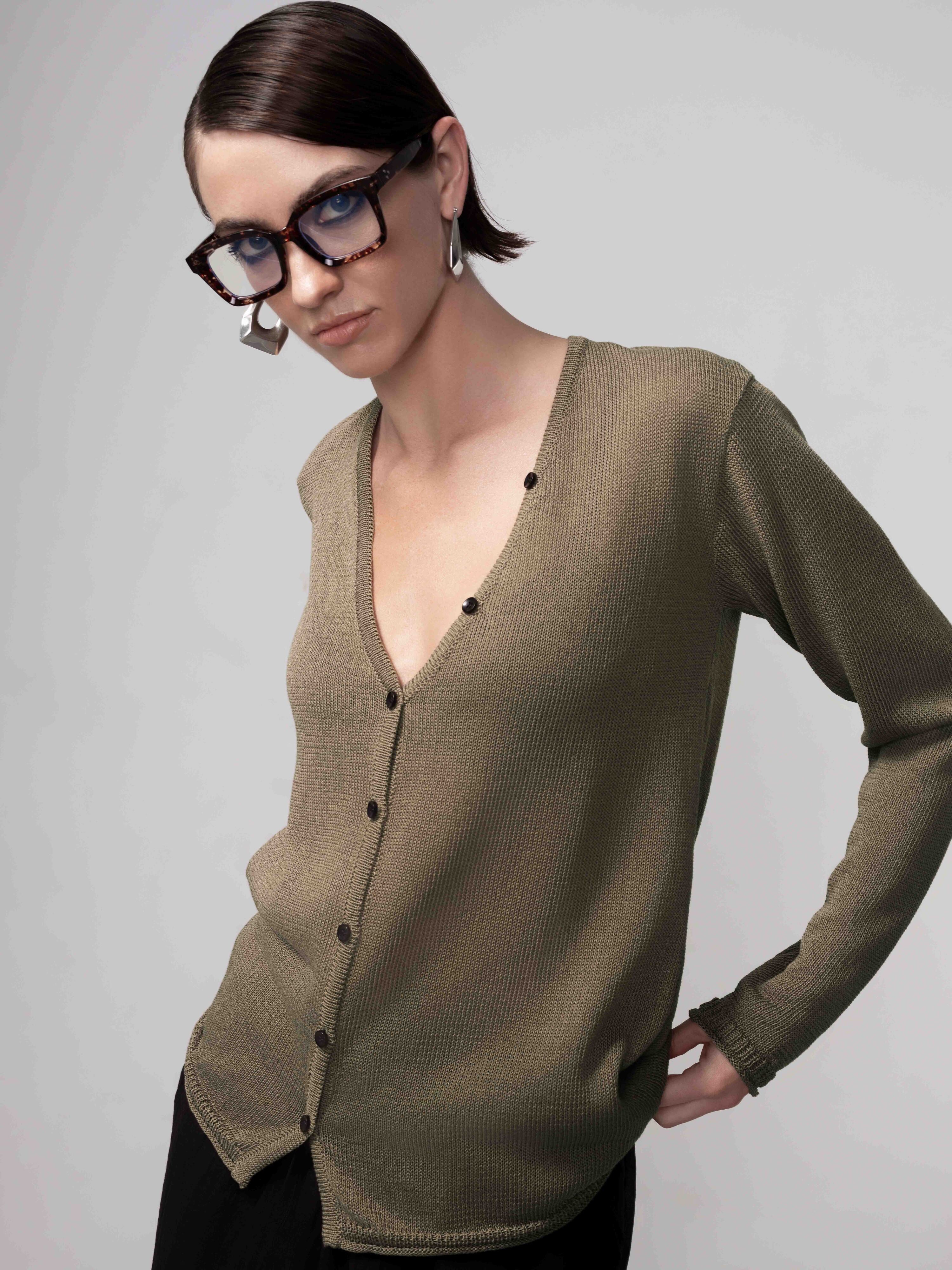 Women’s lightweight knit cardigan in a soft, neutral tone with a button-front design, V-neckline, and relaxed fit, styled with long sleeves and a smooth drape for an effortlessly polished look.
