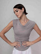 Sleeveless drape neck pullover in a soft knit fabric, featuring a relaxed, body-skimming fit with subtle stretch, styled with a fluid cowl neckline for an elegant, modern look.