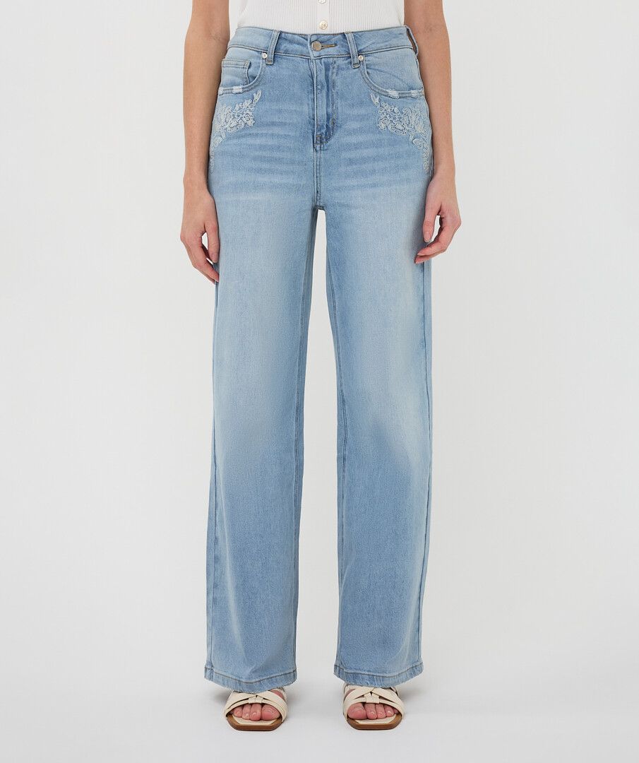 Front view of light wash wide-leg jeans featuring subtle embroidery near the front pockets, a mid-rise fit, and a straight, flowing leg.