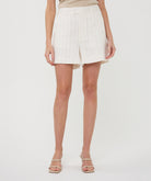 Front view of women's cream pinstripe linen-blend tailored shorts with belt loops and a relaxed fit