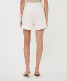 Back view of women's cream pinstripe linen-blend tailored shorts with welt pockets and a relaxed silhouette