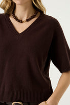 Woman modelling the Nora V-Neck Knit in dark brown