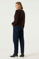 Back view of the Alora Soft Texture Sweater in rich brown, featuring a relaxed fit and long sleeves, styled with dark wash jeans and ankle boots