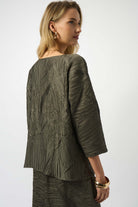 the back of a woman wearing deep-green shirt