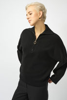 woman standing in black sweater