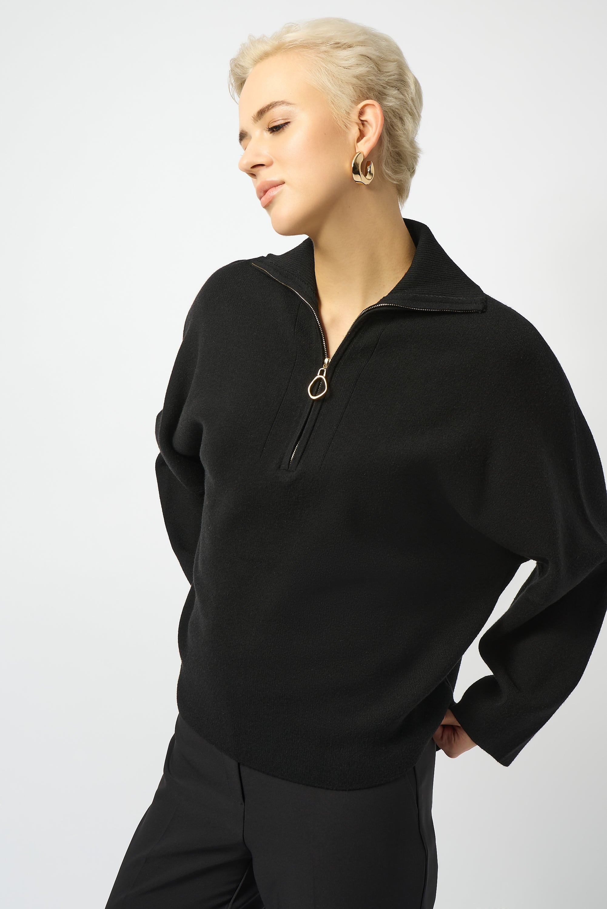woman standing in black sweater