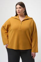 woman standing in mustard yellow sweater