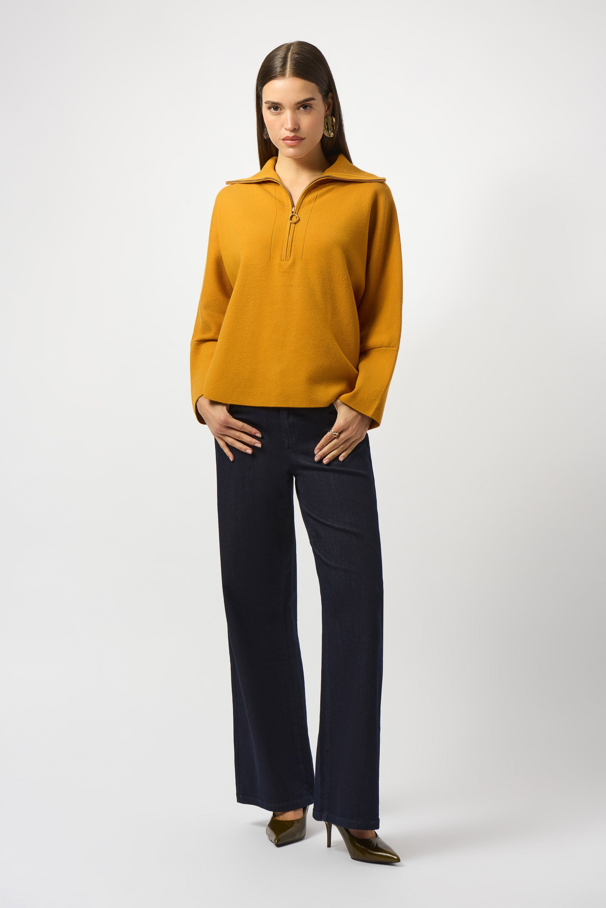 woman standing in mustard yellow sweater
