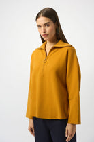 woman standing in mustard yellow sweater