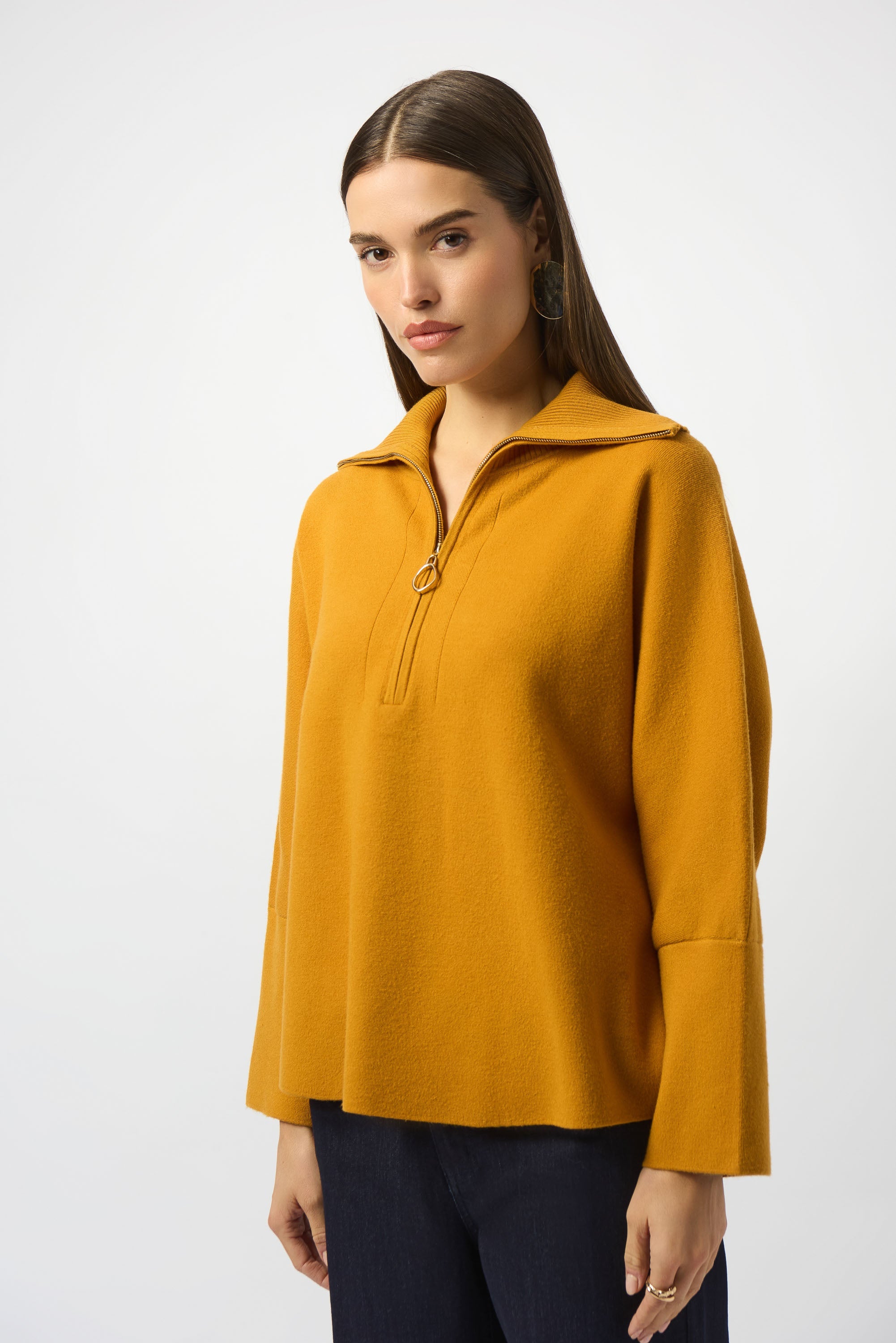 woman standing in mustard yellow sweater